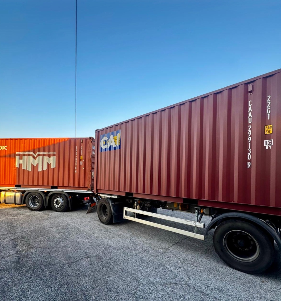 CAI and HMM red shipping container trucks