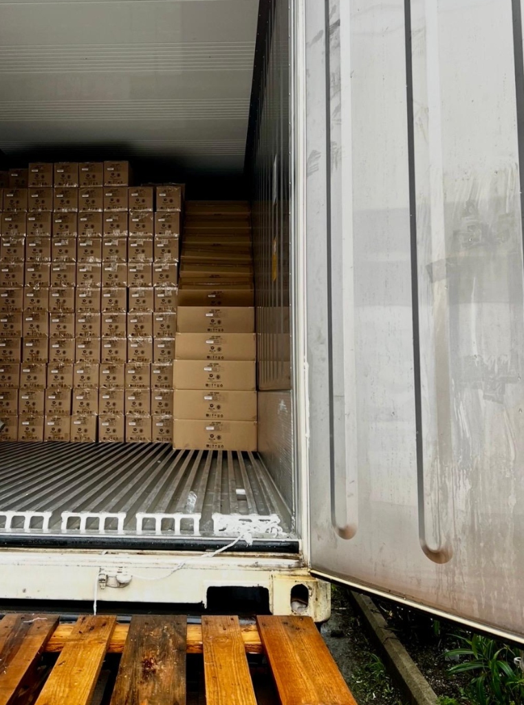 Interior view of container loaded with stacked cargo boxes