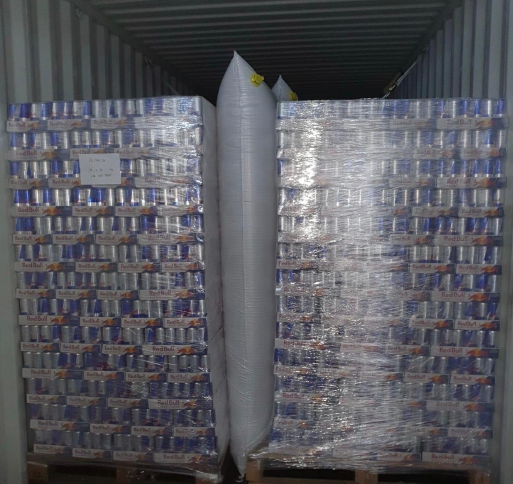 Inflatable dunnage air bags securing beverage pallets in shipping container